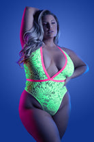 Model wearing plus size neon lace bodysuit by CT Lingerie in neon green lace with pink trim and plunging neckline