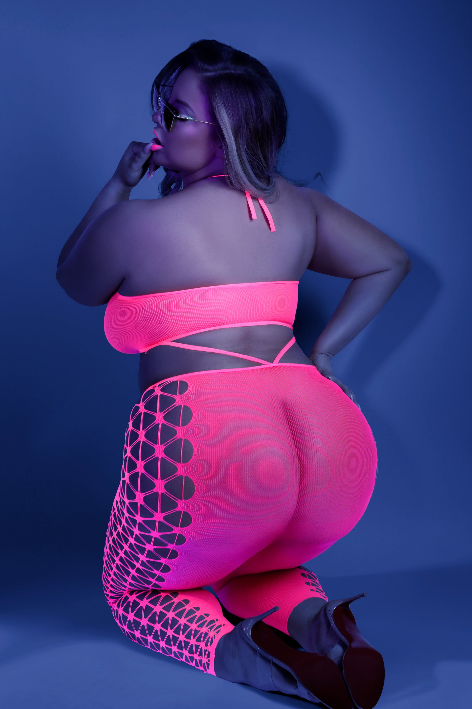 CT Lingerie plus size lingerie set neon pink bodystocking with strappy side cutouts back view kneeling