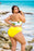 CT Lingerie Linnea reversable plus size bikini swimsuit with yellow and floral patterns modeled outdoors