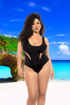Plus size model wearing black CT Lingerie Passion classic one piece swimsuit on a tropical beach