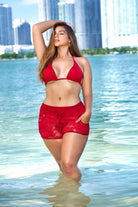 Plus size swimwear featuring red bikini top and Autumn floral lace cover up bottoms at the beach