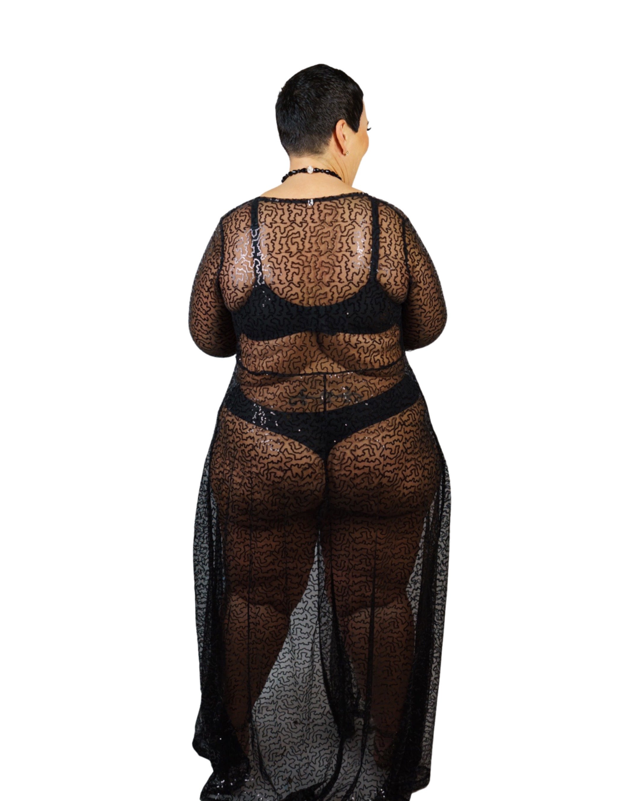 Plus size model wearing a sexy black lace robe back view with matching bra and panty on white background